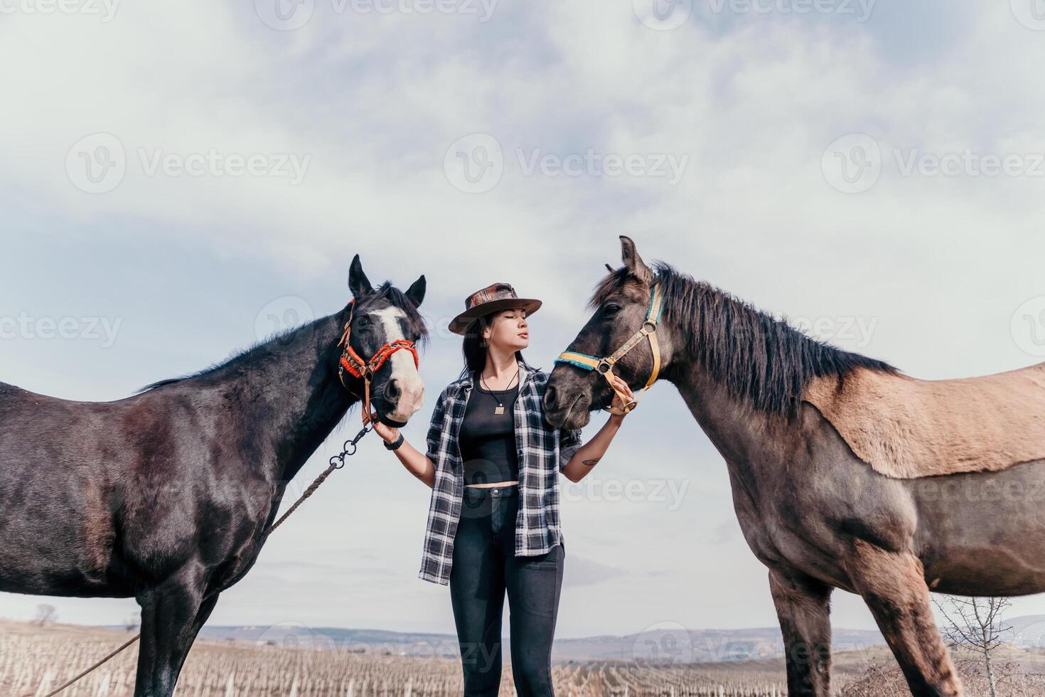 Young happy woman in hat with her horse in evening sunset light. Outdoor photography with fashion model girl. Lifestyle mood. Concept of outdoor riding, sports and recreation. photo