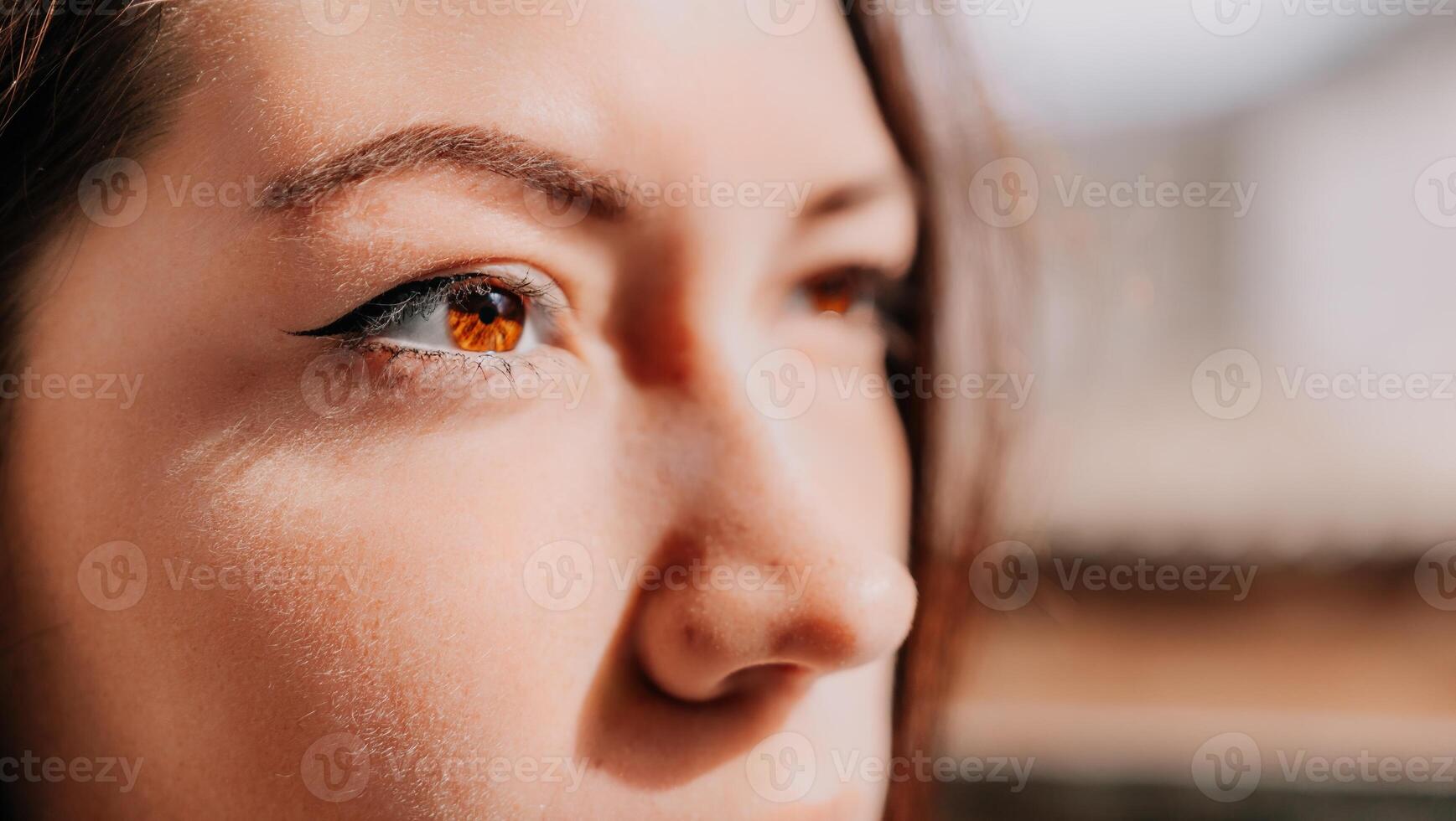 Happy young smiling woman with freckles outdoors portrait. Soft sunny colors. Outdoor close-up portrait of a young brunette woman and looking to the camera, posing against autumn nature background photo