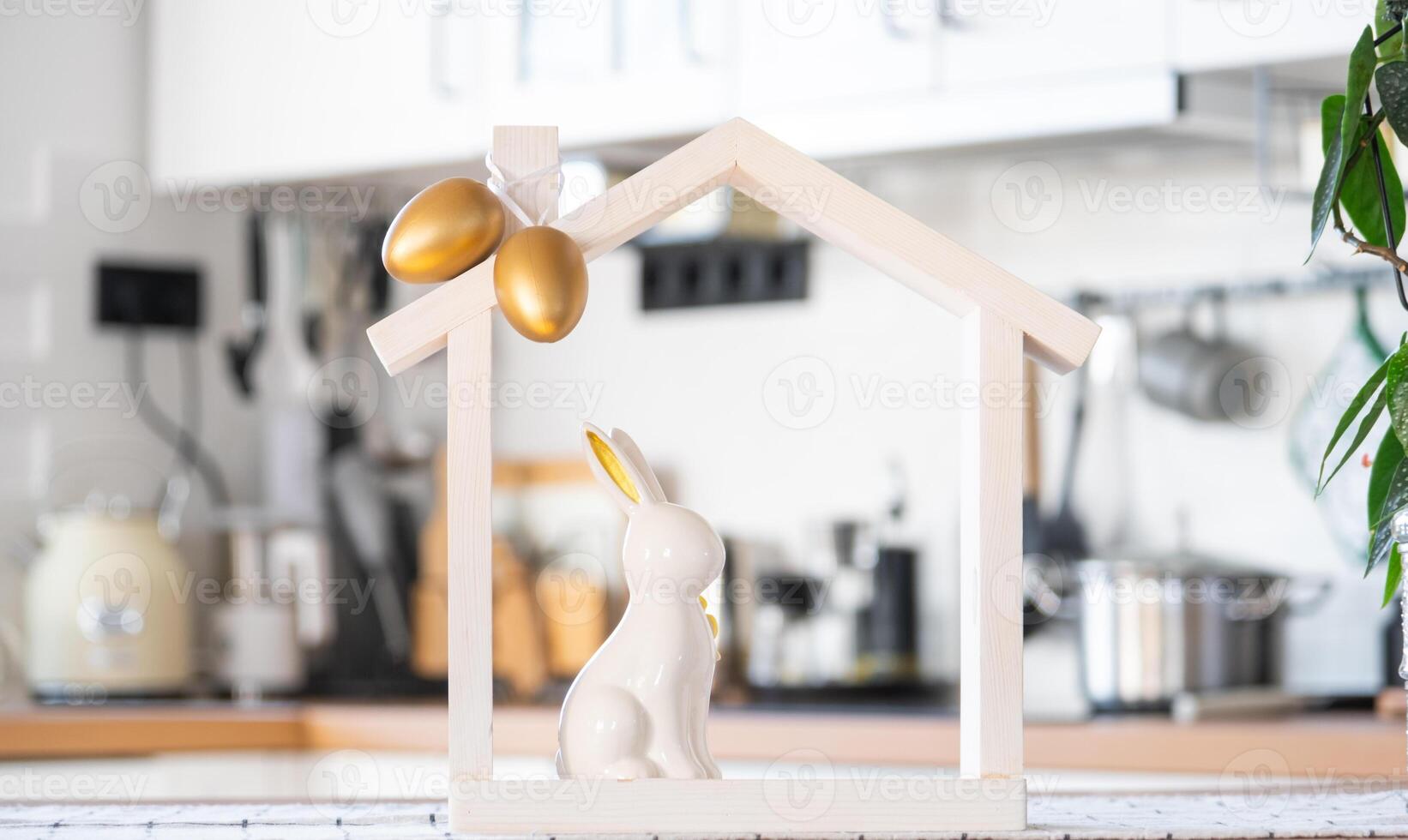 Tiny house of cozy home with Easter decor with rabbit and eggs on table of kitchen. Building, design, project, moving to new house, mortgage, insurance, rent and purchase real estate photo