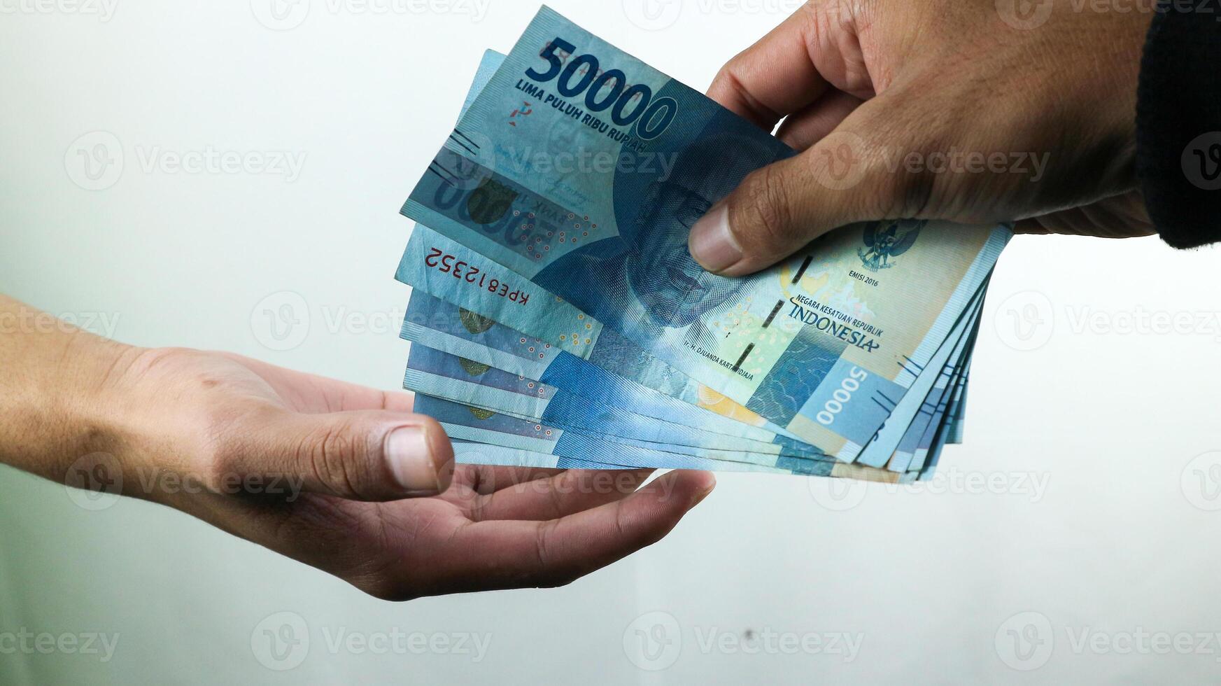 Hand hold money rupiah,transaction concept, financial concept photo