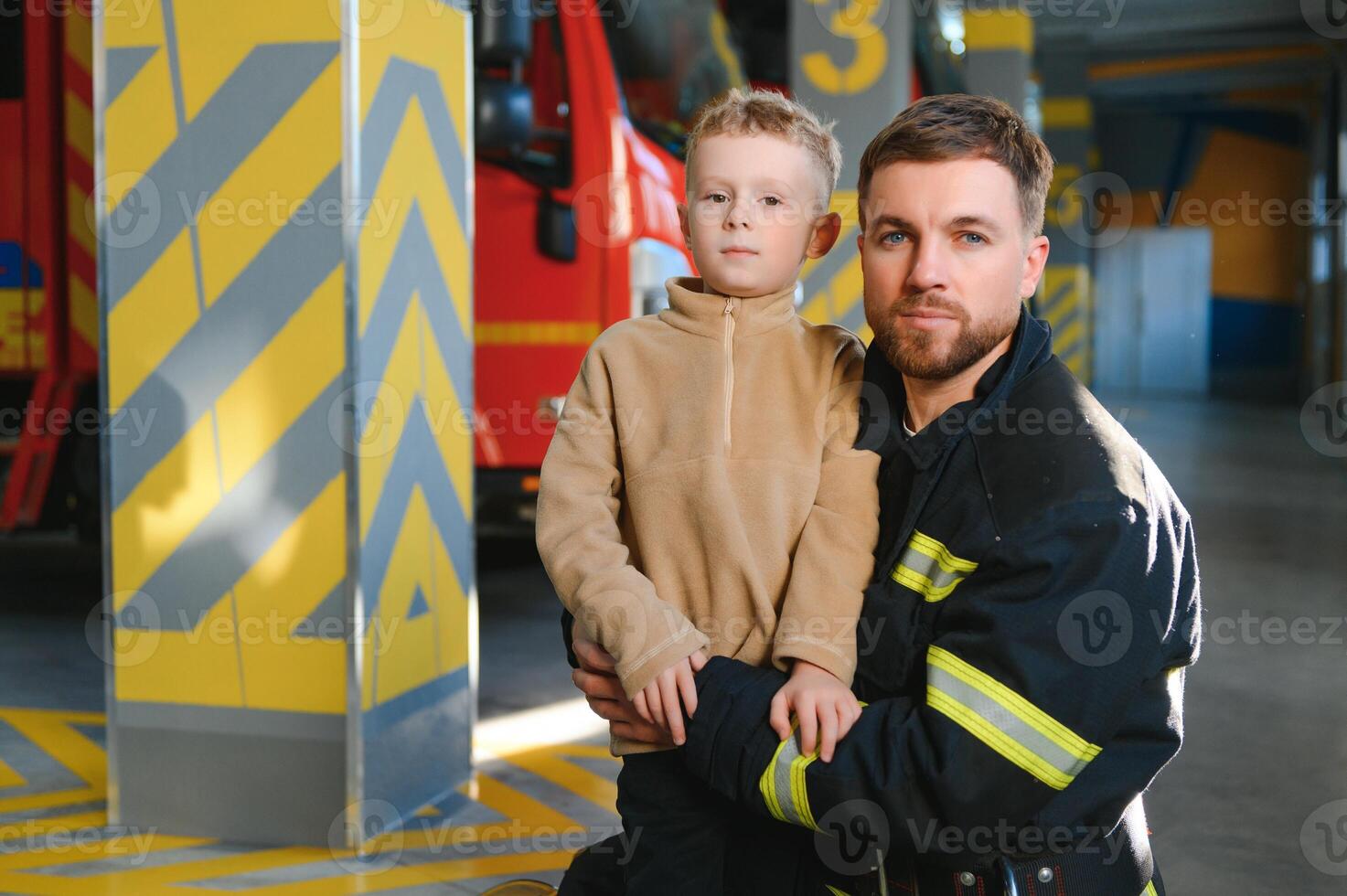 Firefighter holding child boy to save him in fire and smoke,Firemen rescue the boys from fire photo