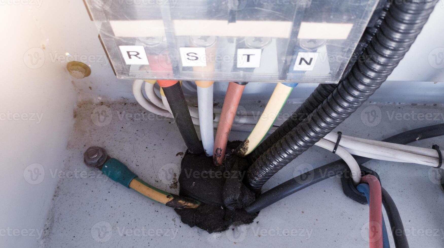 Three phase cables power input , neutral and grounding cable on the panel control. Terminal Block R-S-T-N for three phase Electrical system wiring. photo