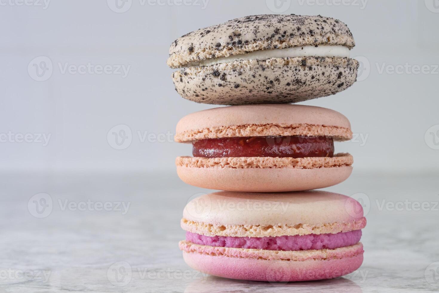 Stack of Three Macaroons on a Marble Surface photo