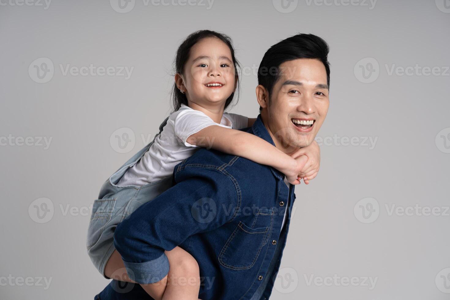 Portrait of father and daughter posing on white background photo