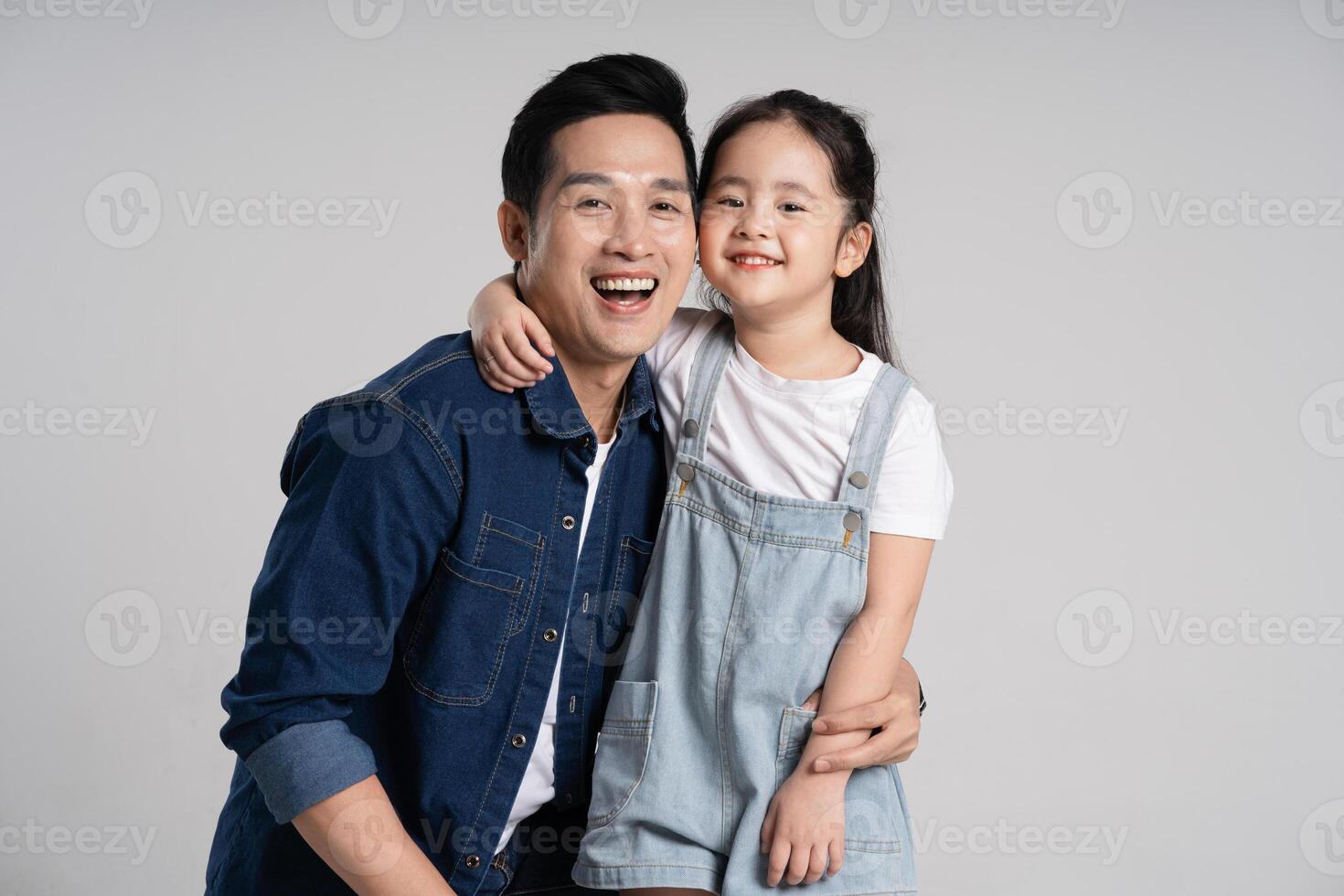 Portrait of father and daughter posing on white background photo