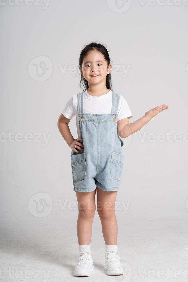 Portrait of a lovely Asian baby girl posing on a white background photo