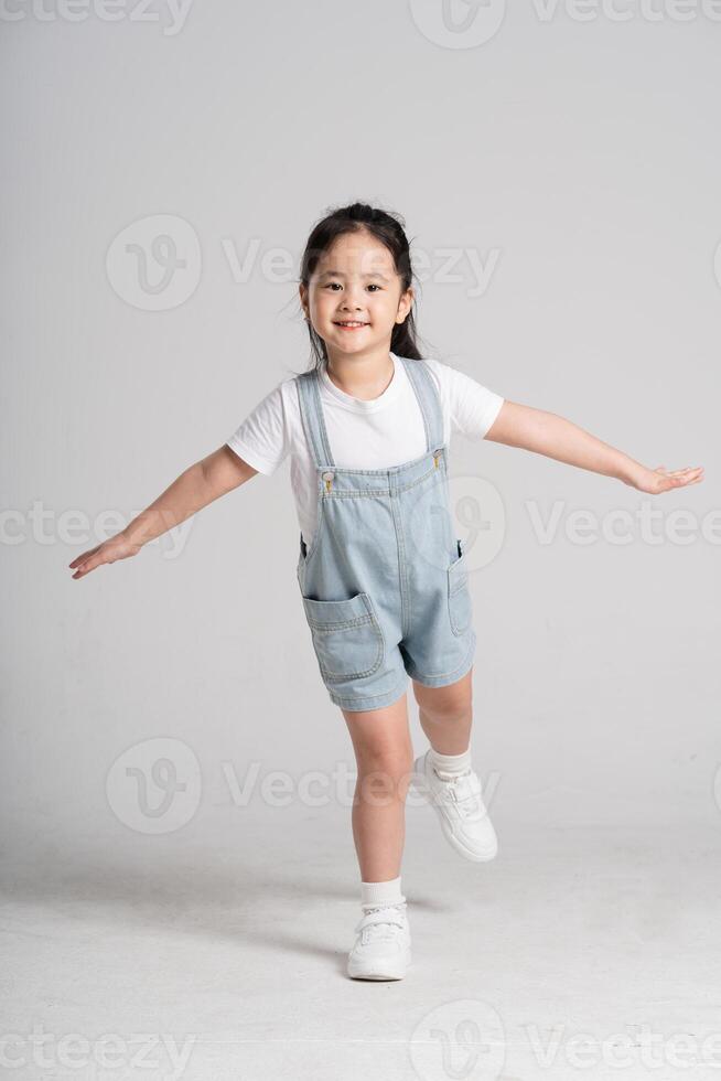 Portrait of a lovely Asian baby girl posing on a white background photo