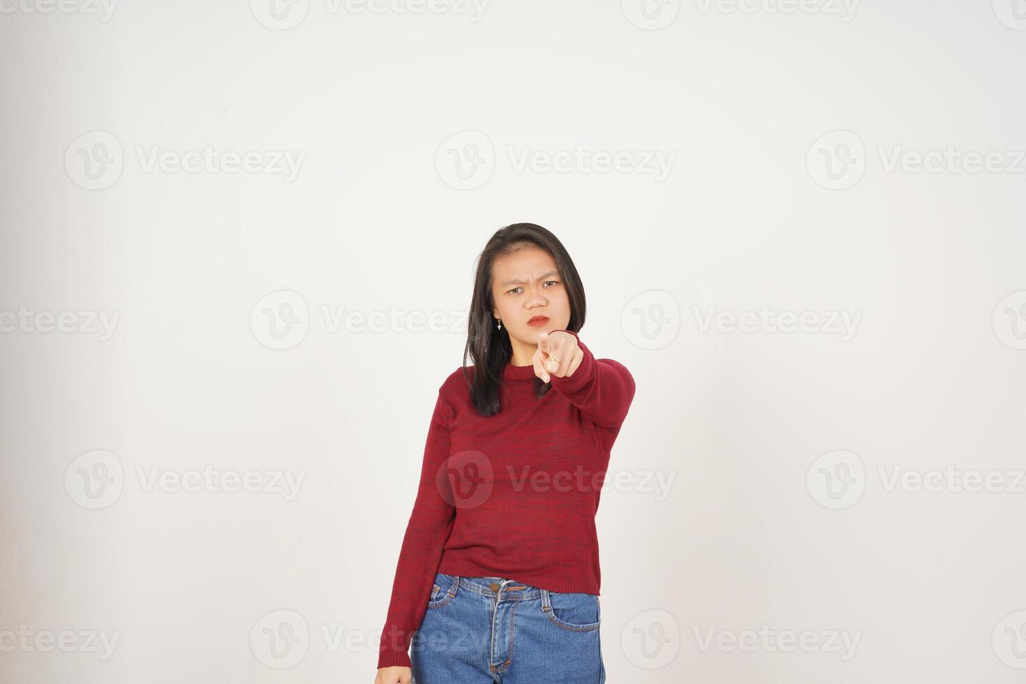 Young Asian woman in Red t-shirt Pointing at You with angry gesture isolated on white background photo