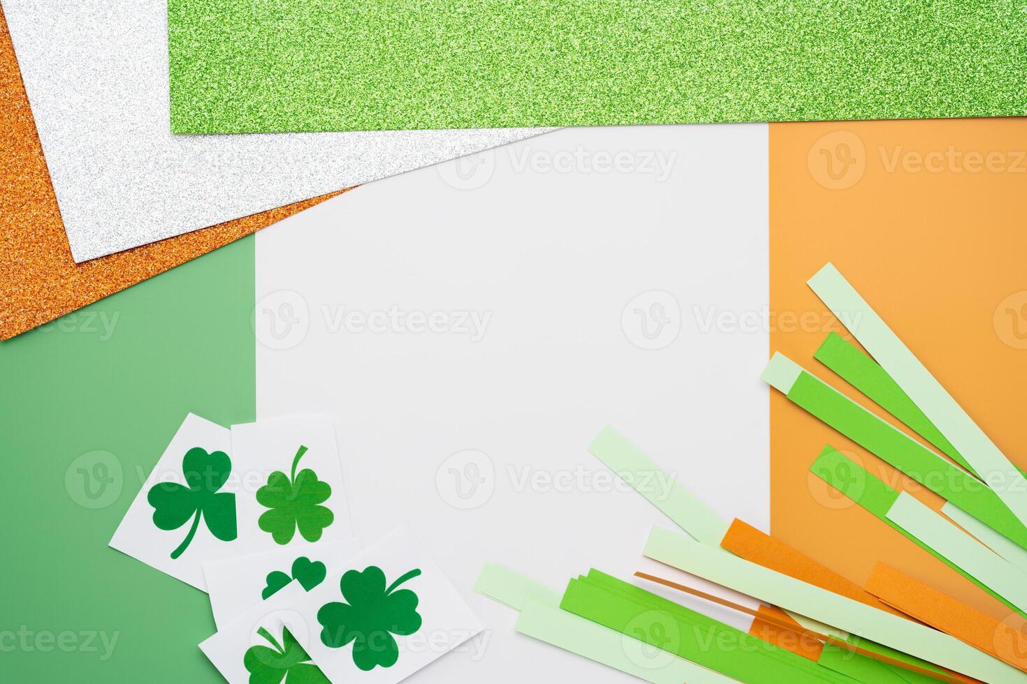 Irish flag made from color paper with cut out shamrock clover and glitter paper photo