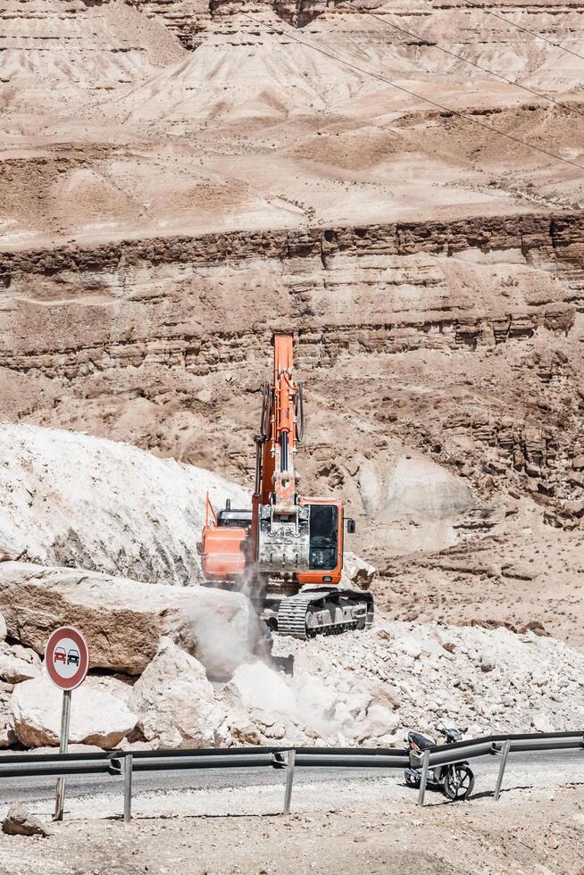 Excavator building a mountain road in the atlas mountain photo