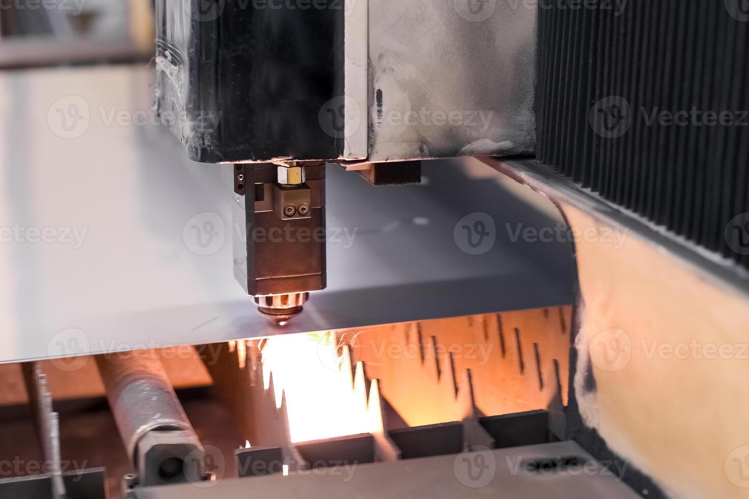 Old Automated CNC laser machine cuts stainless steel sheet. Laser cutting of metal photo