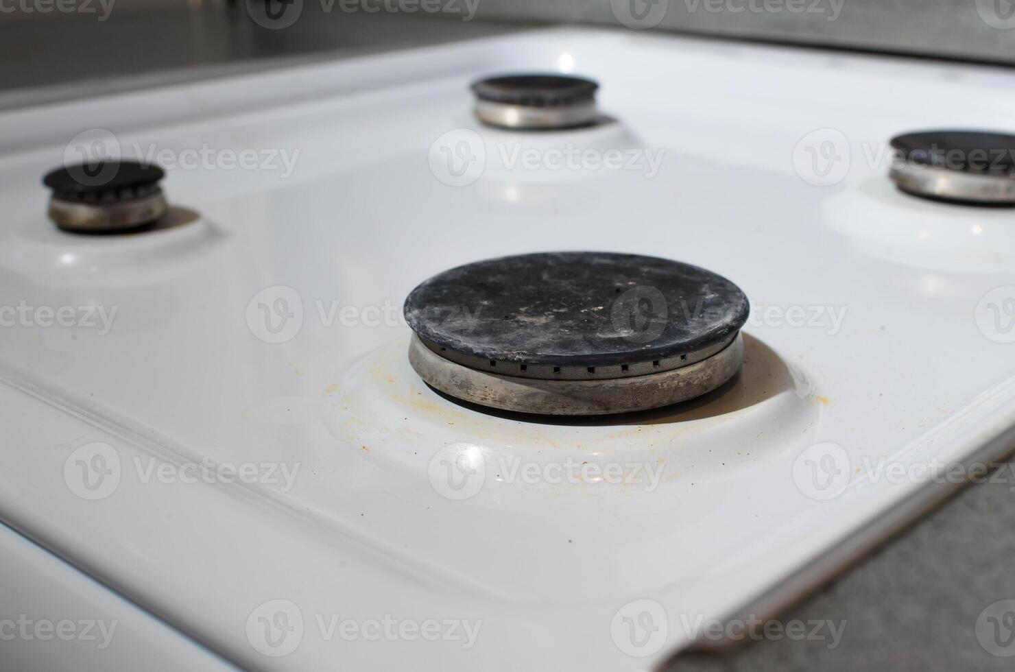 Dirty surface of gas stove, burners. Household hygiene concept. photo