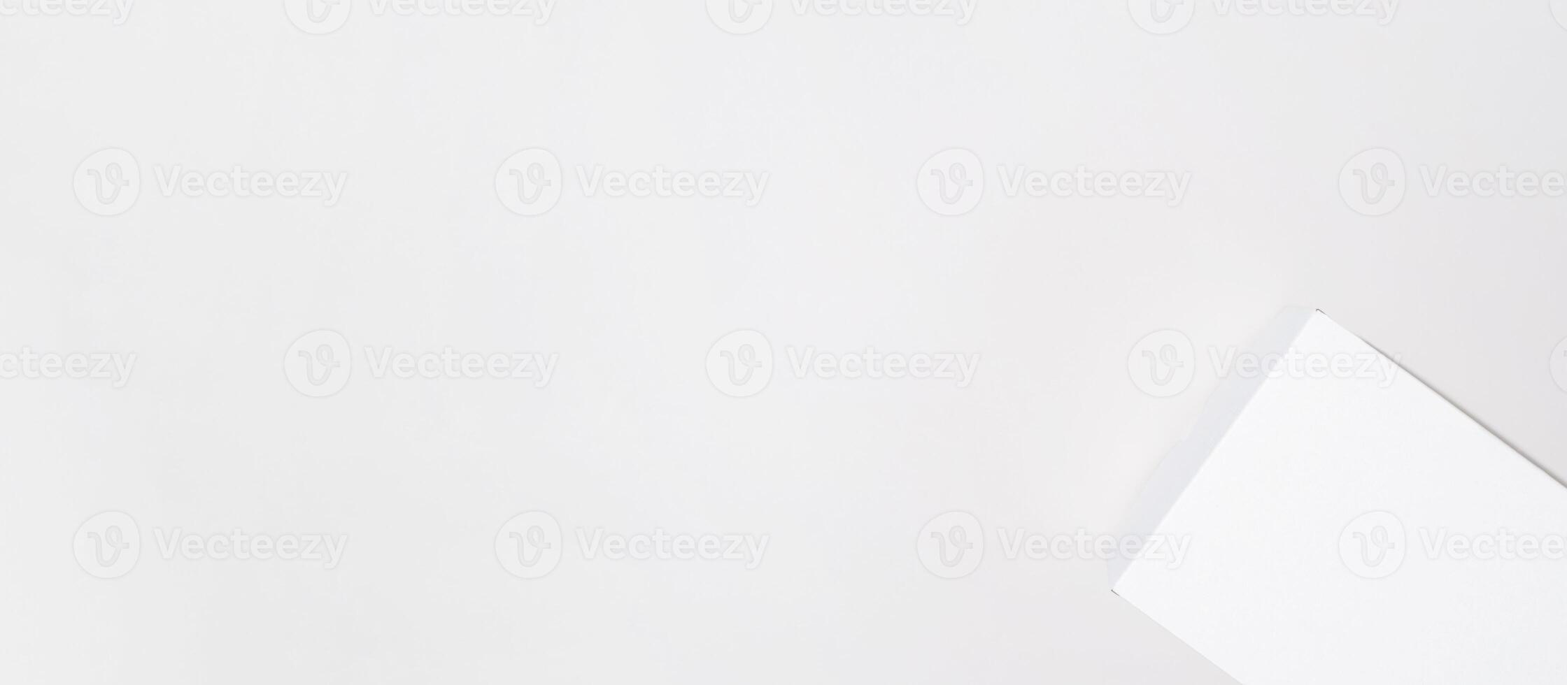White box mock up banner, copy space. Small cardboard box with closed lid on a light background, top view photo
