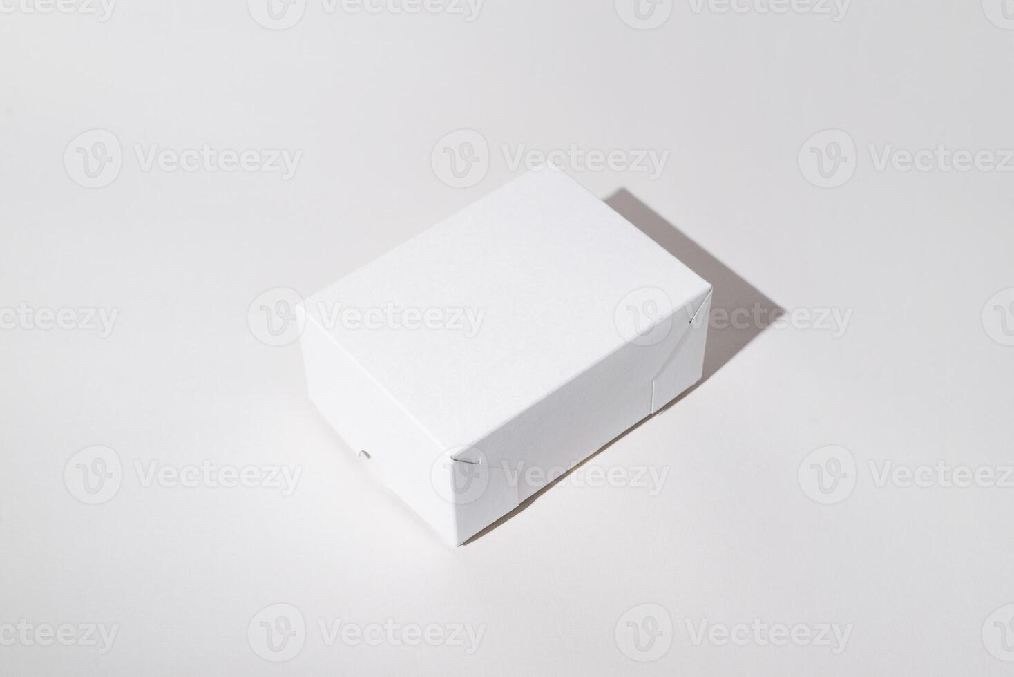 Small box mock up on a white background. Blank cardboard box surface side view, copy space. photo