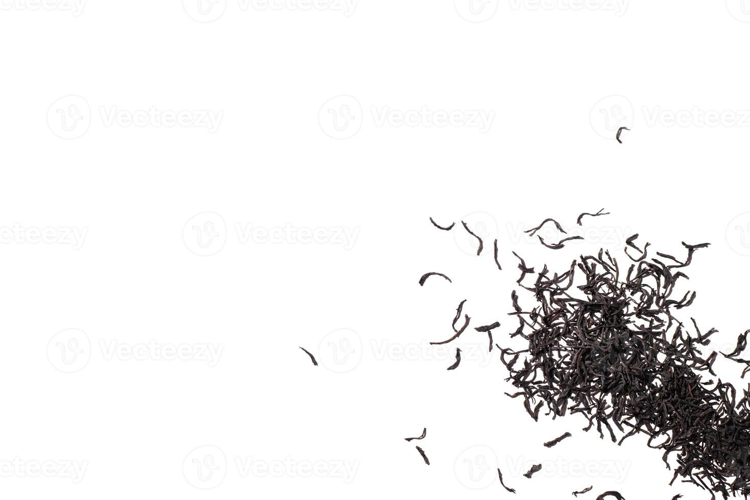 Black tea leaves isolated on white background. Scattered dry tea leaves. Top view, copy space photo