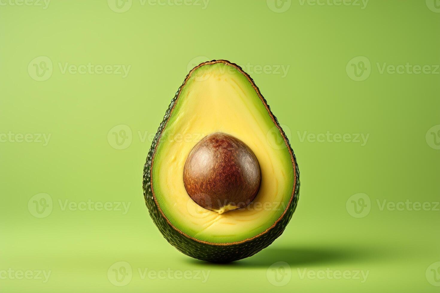 AI generated Avocado with a pit in a section on a green background, food minimalism photo