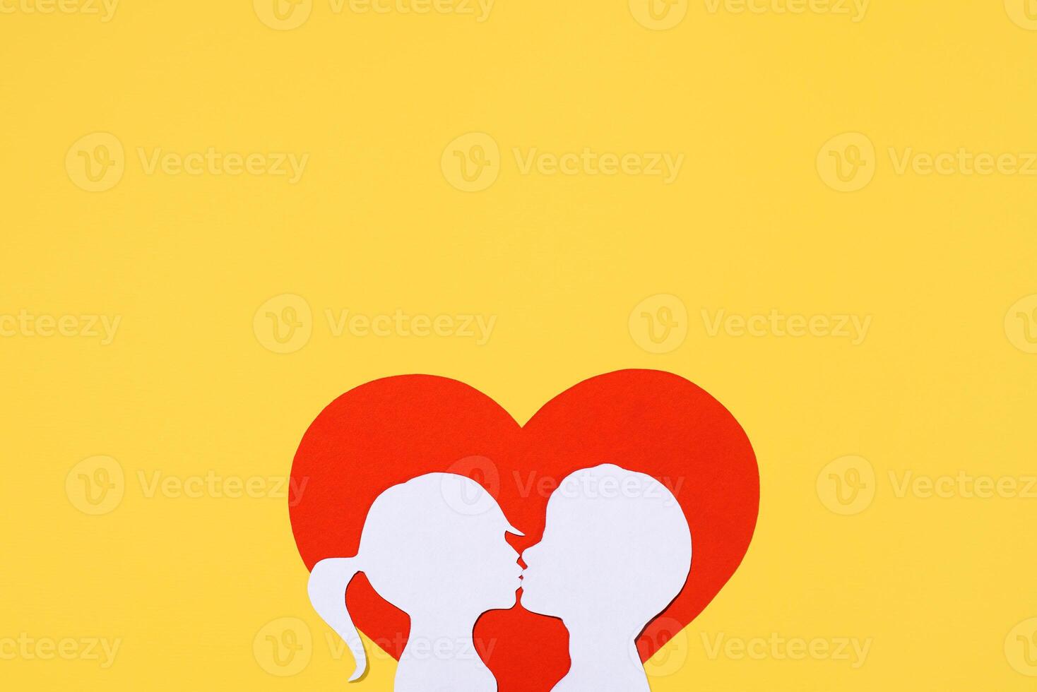Kissing girl and boy silhouettes on heart shaped background. Valentine's Day concept. Creative love card. Flat lay, top view, copy space photo