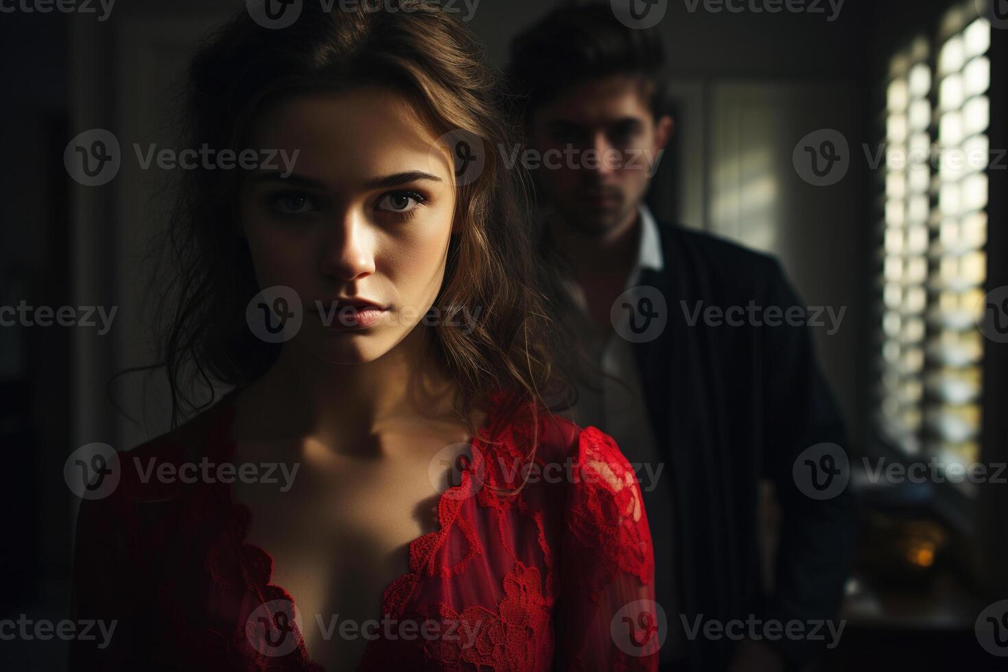 ai generado relación problema, pelea concepto. grave triste mujer en rojo vestir mirando a cámara y hombre detrás atrás, adentro foto