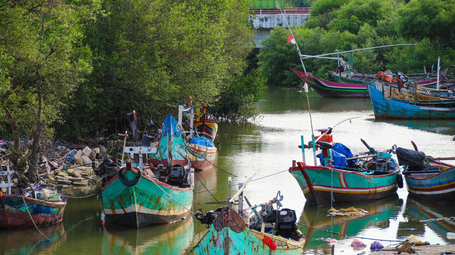 View of a fishing boat as it rests on the river bank photo