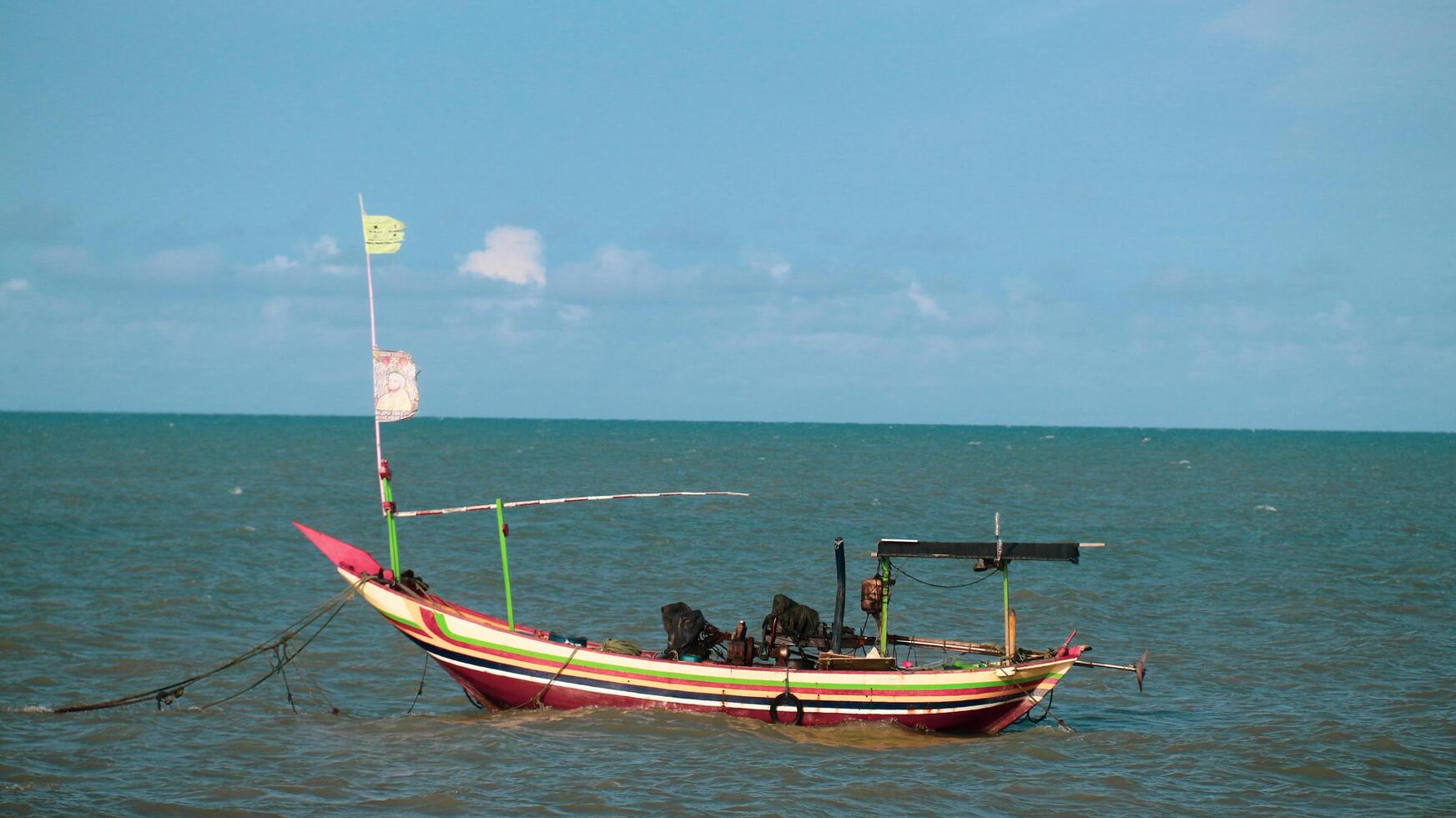 Fishing boat in the blue ocean photo