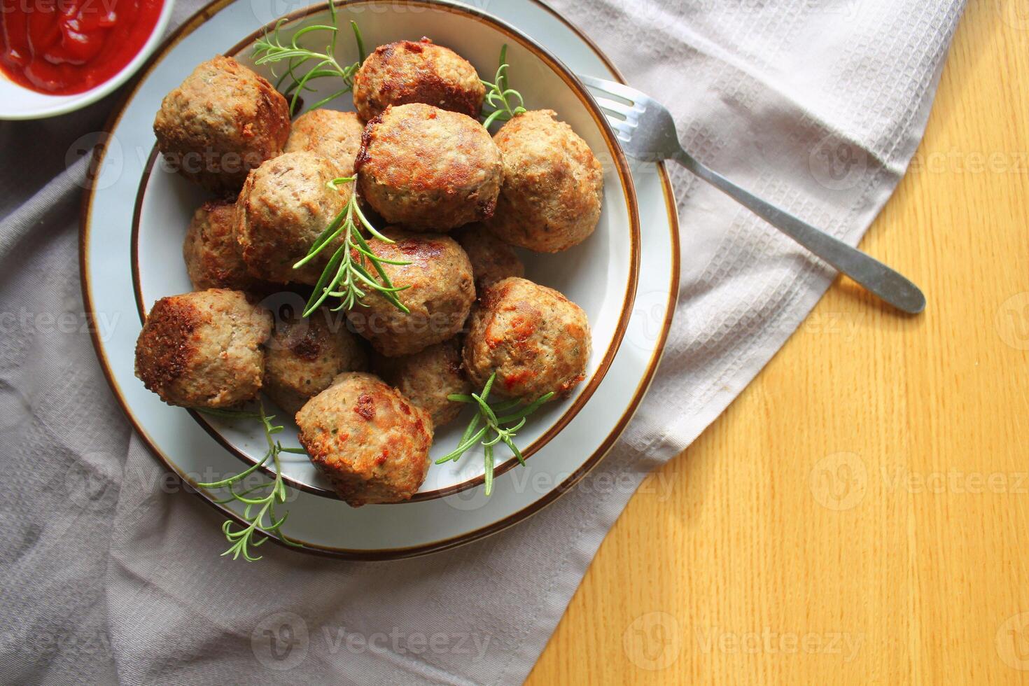 Roasted meatballs , delicious meat cutlets on wooden table . Top view photo