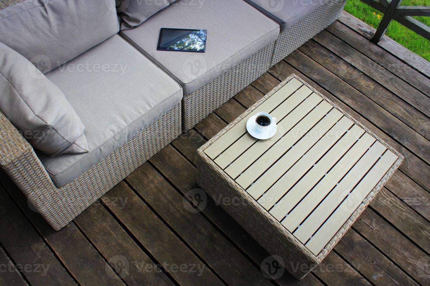 Outdoor furniture lounge group with chairs, sofa and table in a patio. Seating on the balcony, is a recreation place photo