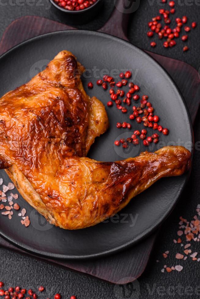 Delicious grilled chicken leg or quarter with salt and spices photo