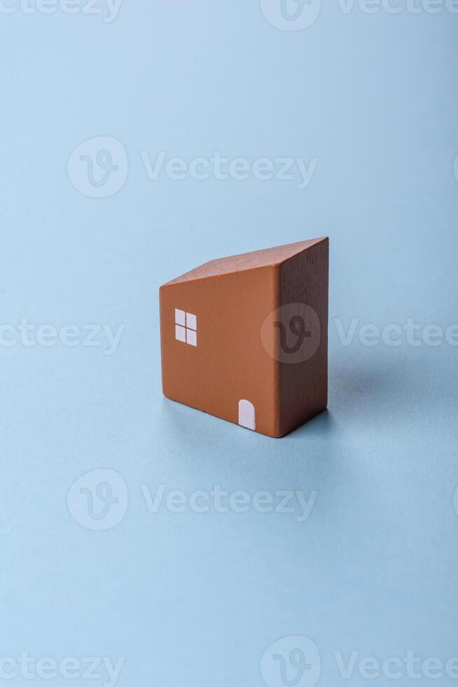 A small wooden house and keys as an idea for investing in your own home photo