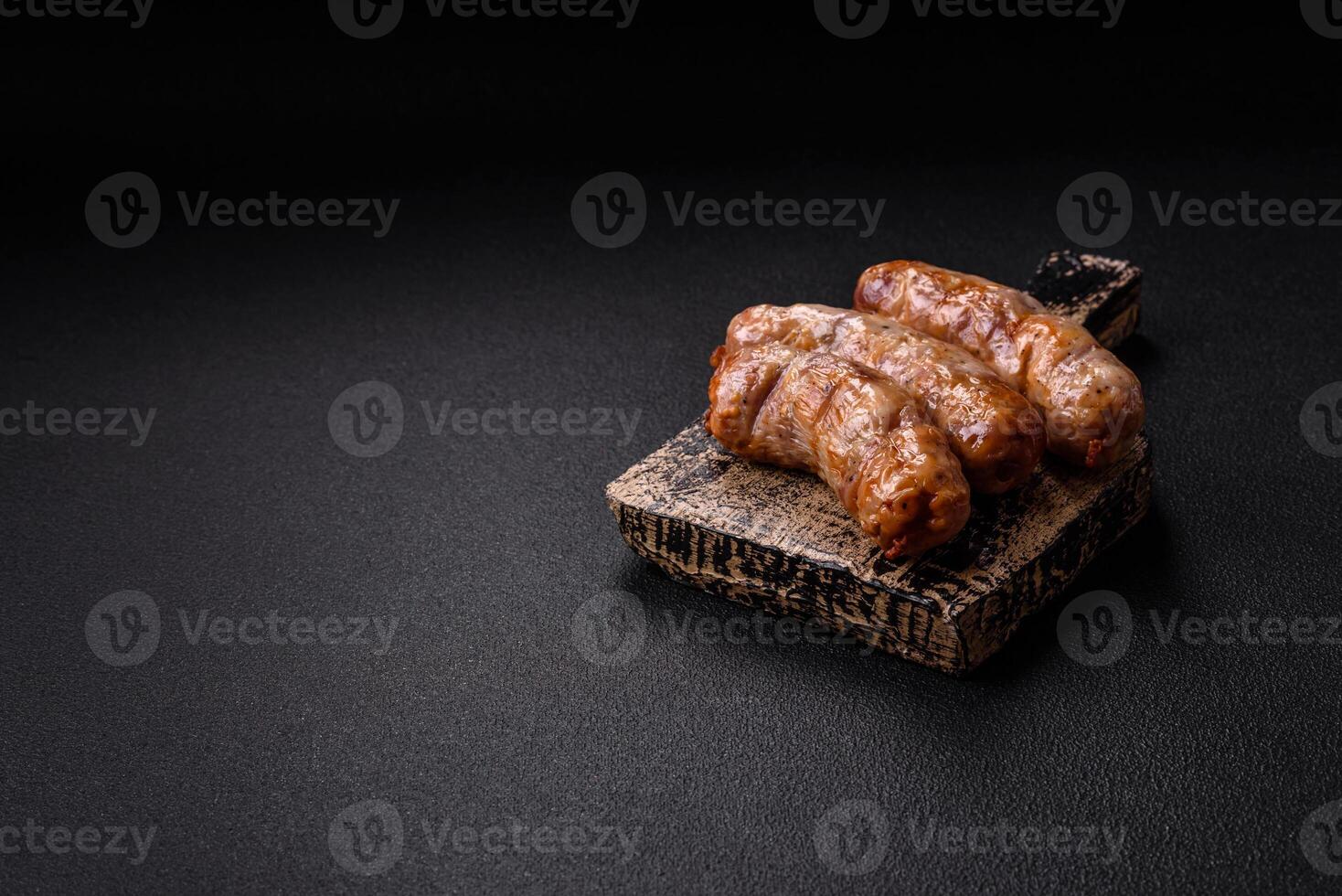 Grilled sausages with spices and herbs. With copy space photo