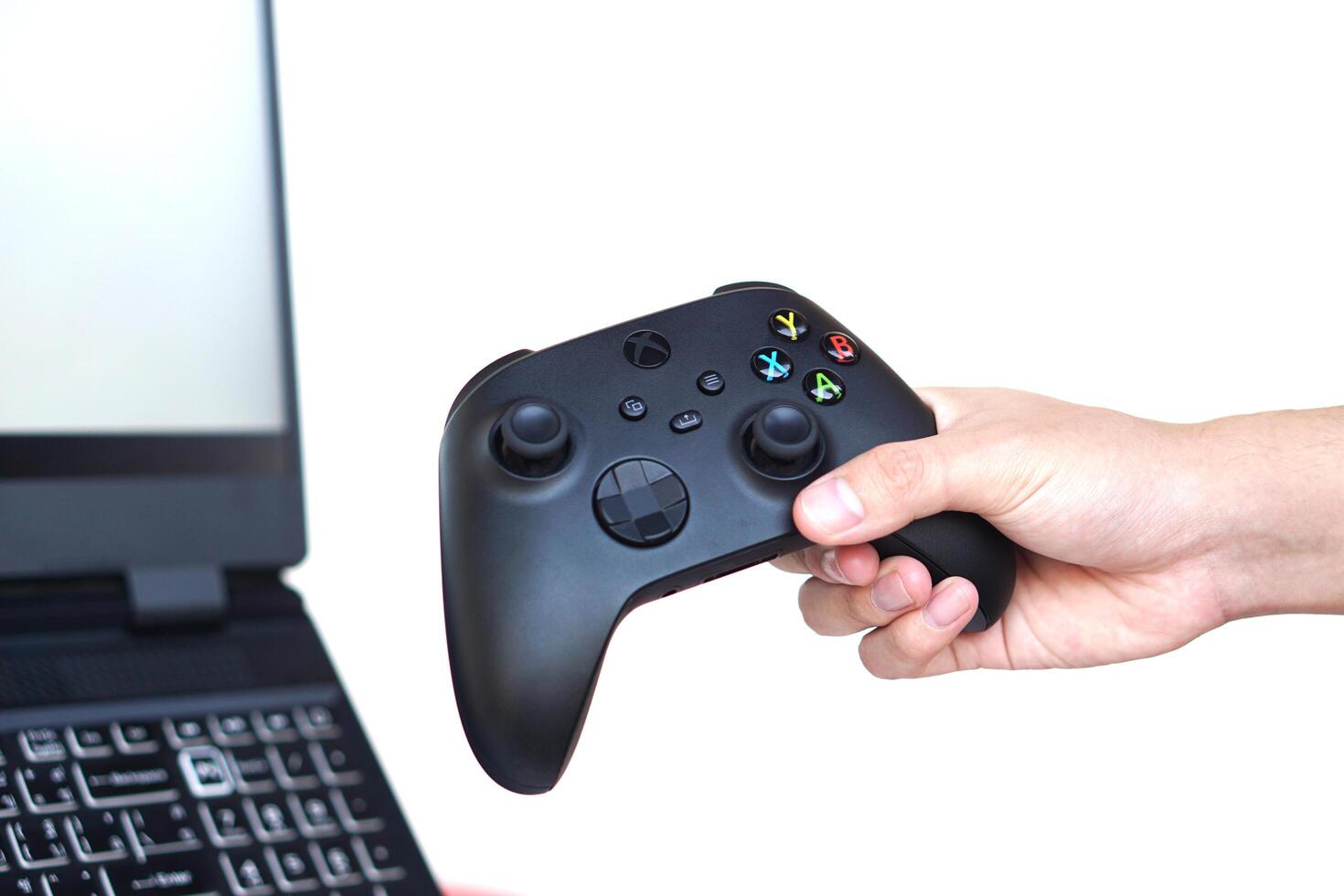 Close up hands hold black joysticks or game controller console. Concept,technology device for entertainment about online remote video games to computer screen. Hobby,freetime and recreation activity. photo