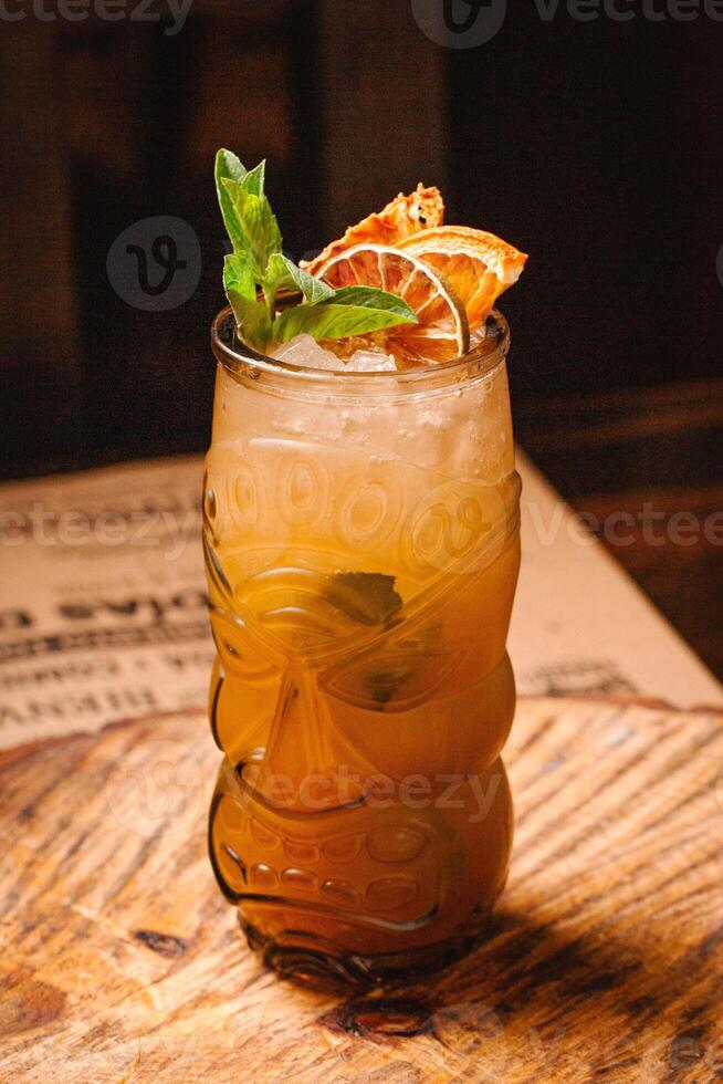 Mai Tai cocktail in tiki glass at a restaurant photo