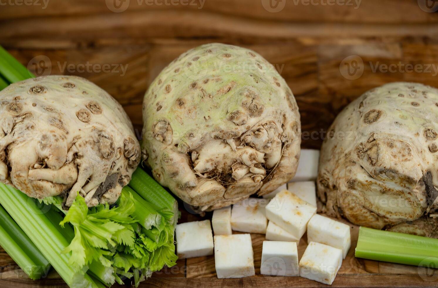 Fresh celery Apium graveolens on olive wood photo