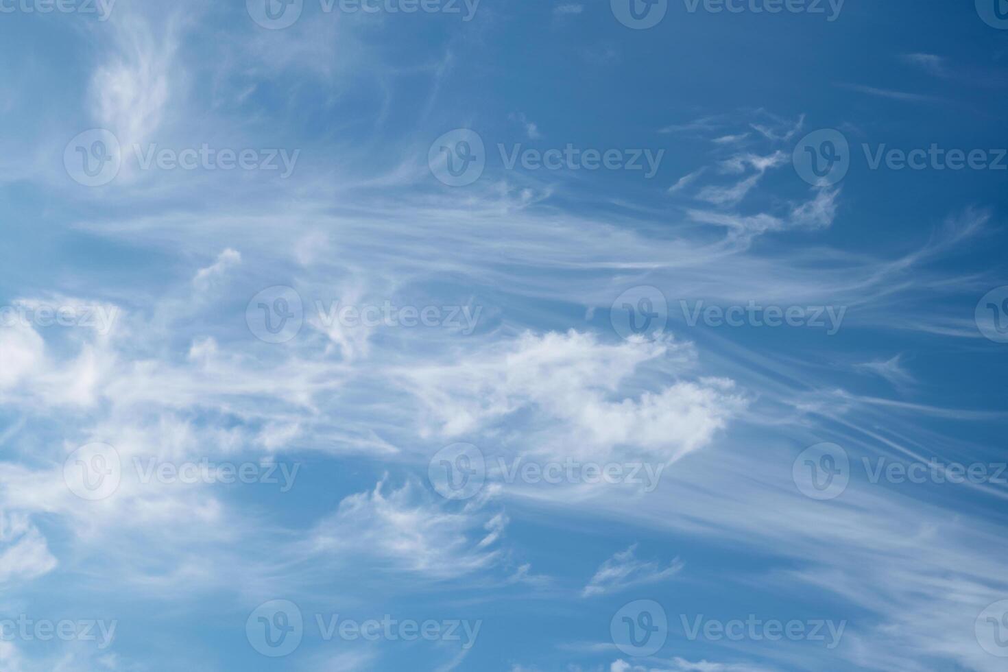 Beautiful wispy cirrus clouds in blue sky on freedom, energize and joyful sunny day photo