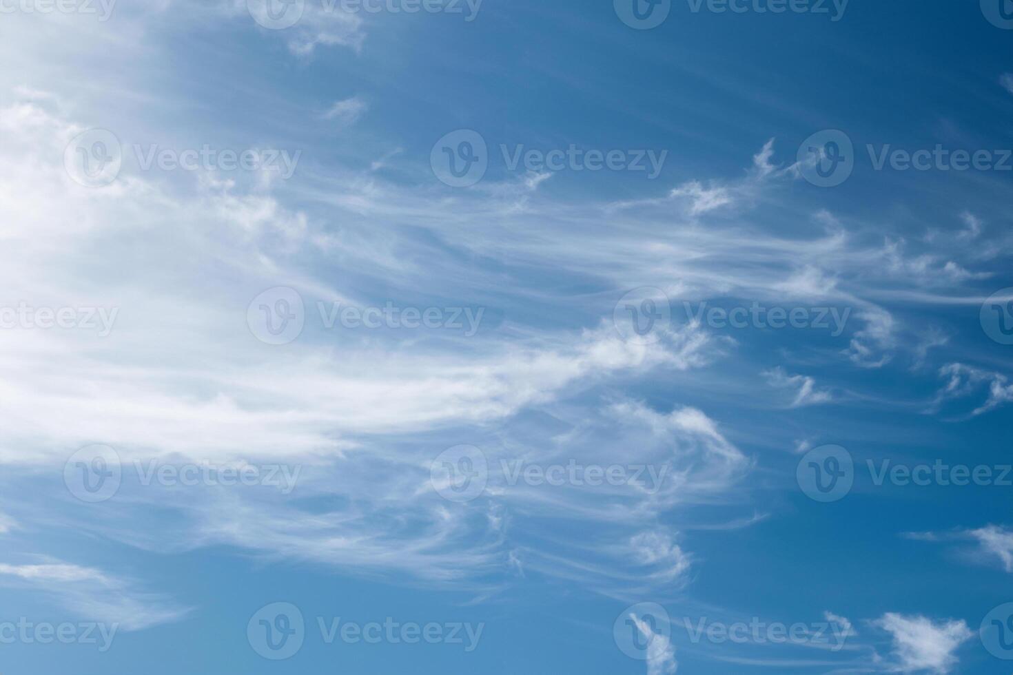 Beautiful wispy cirrus clouds in blue sky on freedom, energize and joyful sunny day photo