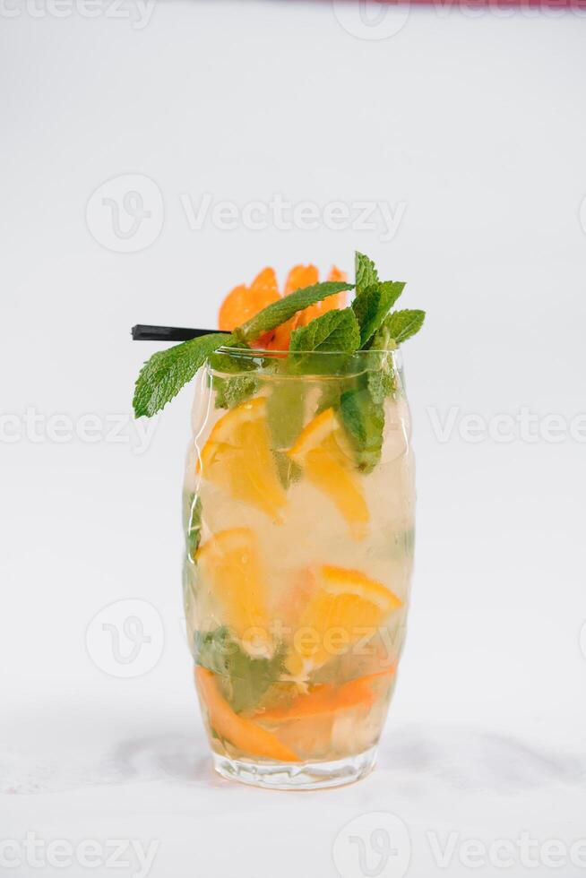 Glasse Of Drink With Ice Cubes And Fruits On White Background. photo