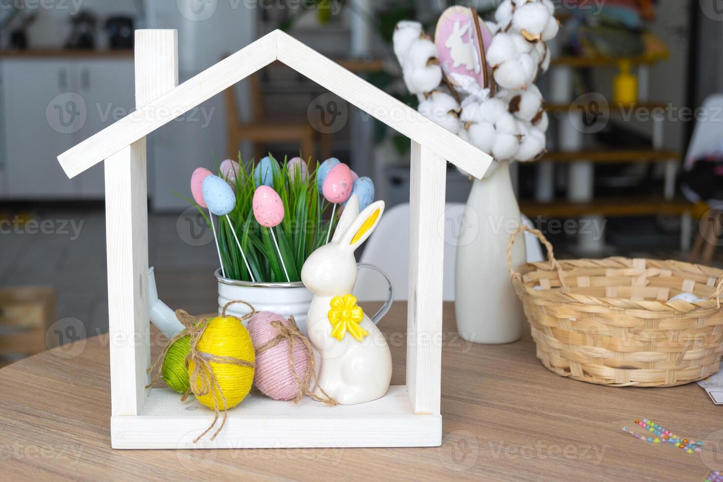 Tiny house of cozy home with Easter decor with rabbit and eggs on table of kitchen. Building, design, project, moving to new house, mortgage, insurance, rent and purchase real estate photo