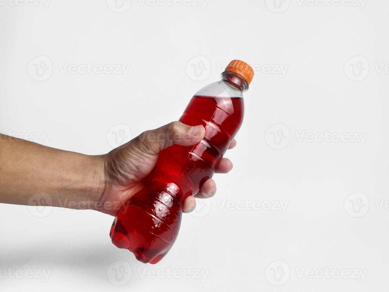 a bottle containing soda is being held by someone photo