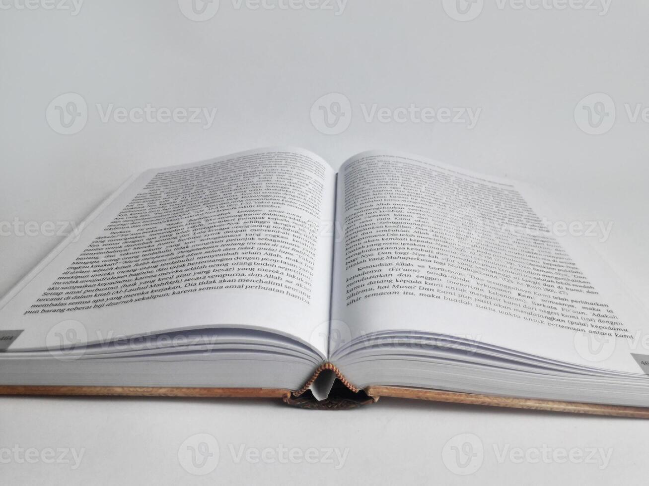 a thick book with its middle page open photo