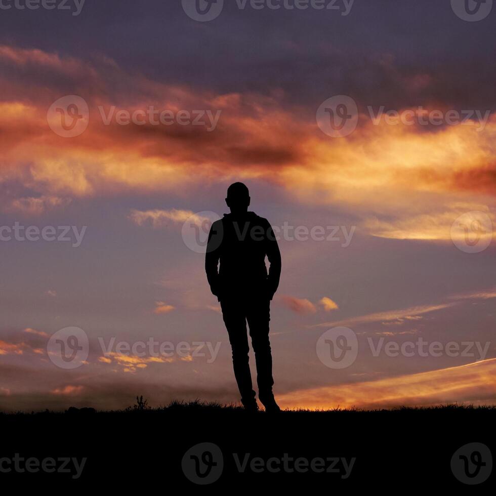 man silhouette in the countryside and sunset background photo