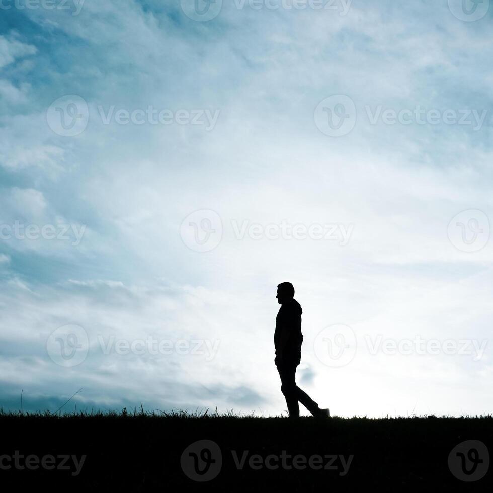 man silhouette in the countryside in the summer and sunset background photo