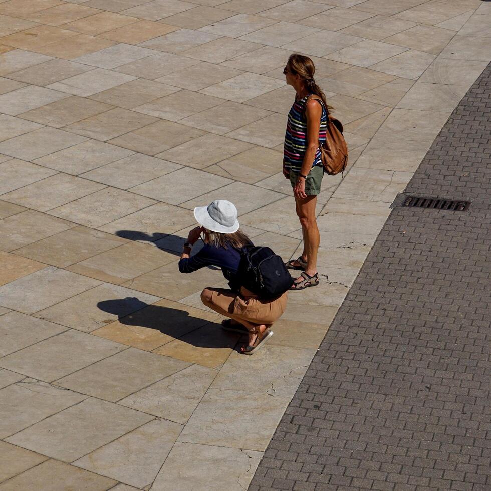Bilbao, Vizcaya, Spain, 2024 - tourist taking photos on the street