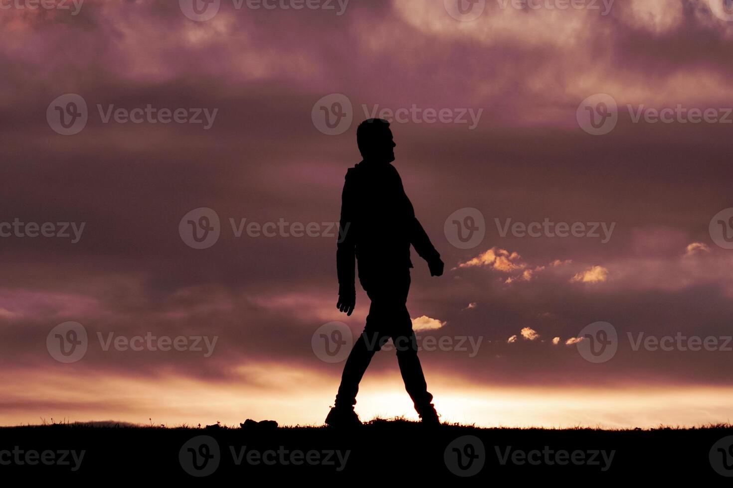 hombre silueta en el campo y puesta de sol antecedentes foto