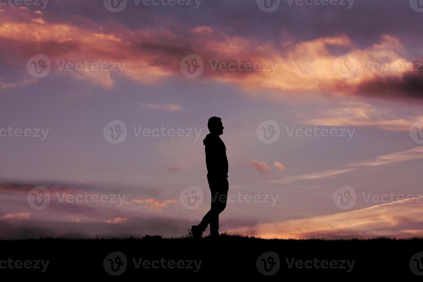 man silhouette in the countryside in the summer and sunset background photo