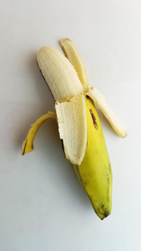 opened yellow banana on a white background photo