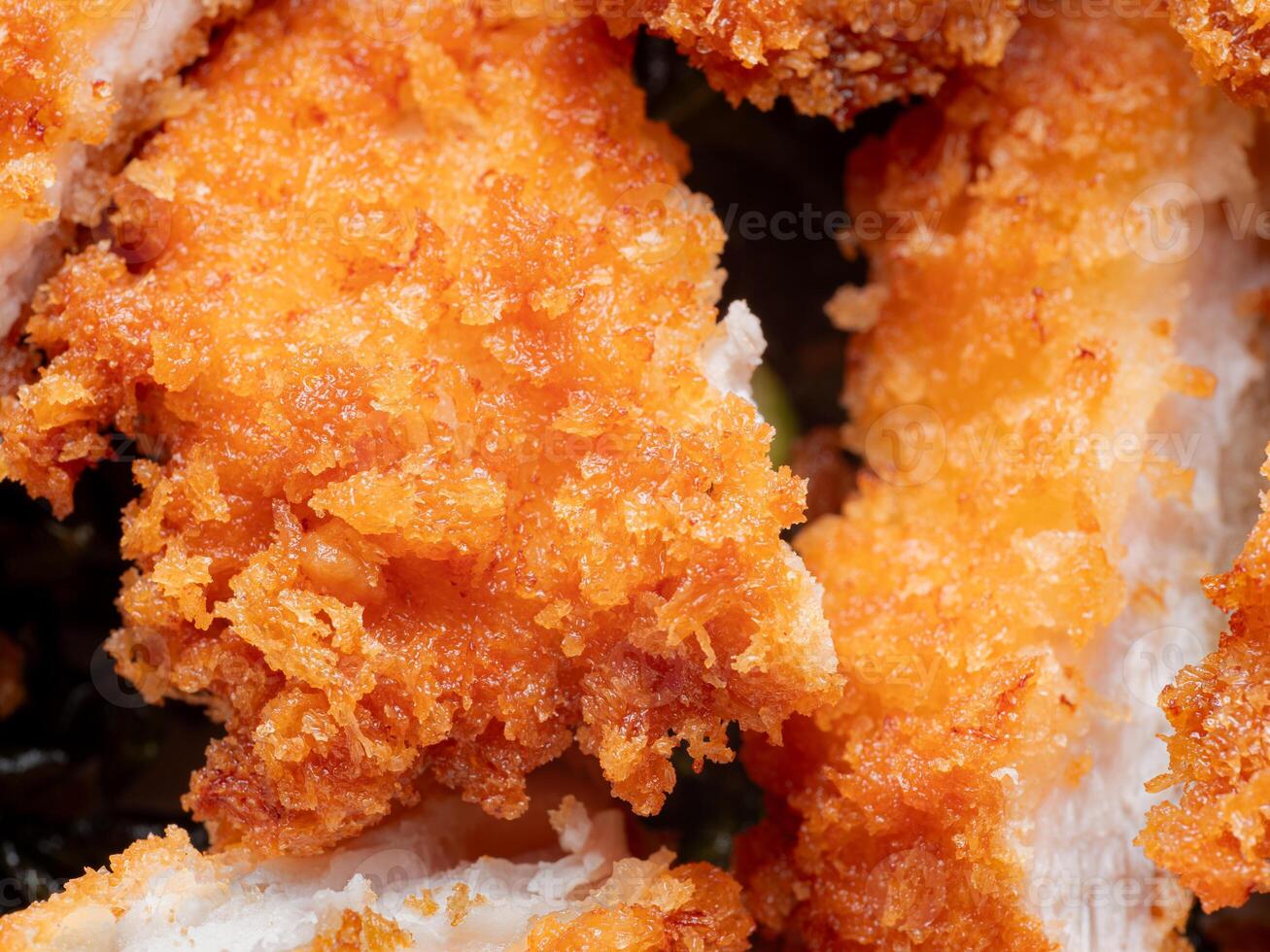 Fried Chicken Ingredients include bread crumbs. One of the most popular fried foods. Chopped or sliced fried chicken placed on a white plate. photo