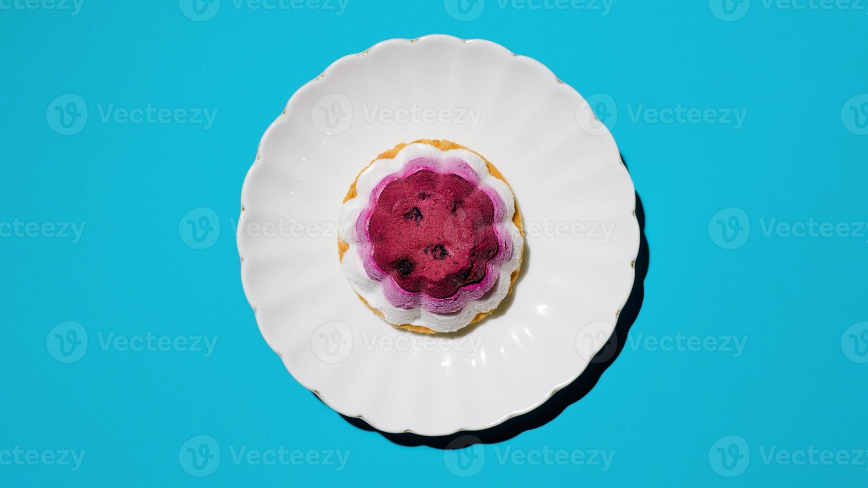 Cake with strawberries on a plate, light blue background. Top view, flat lay, copy space photo