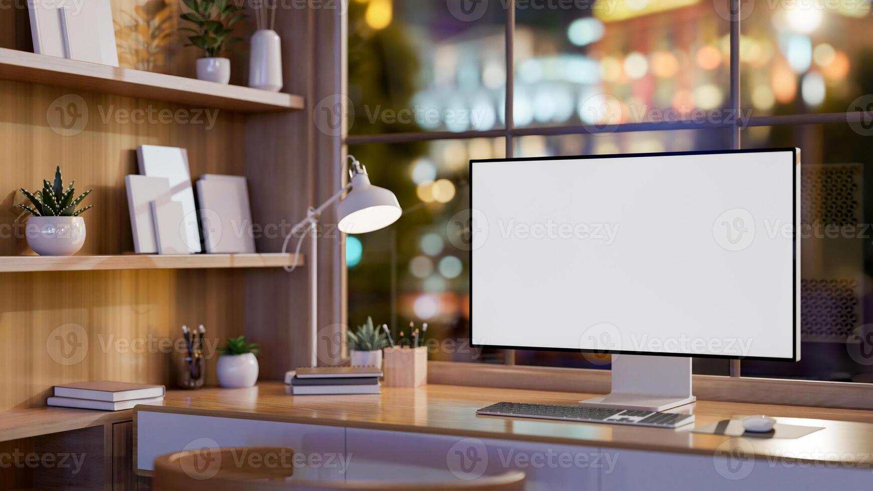 A contemporary office features a computer on a table against the window with a nighttime city view. photo