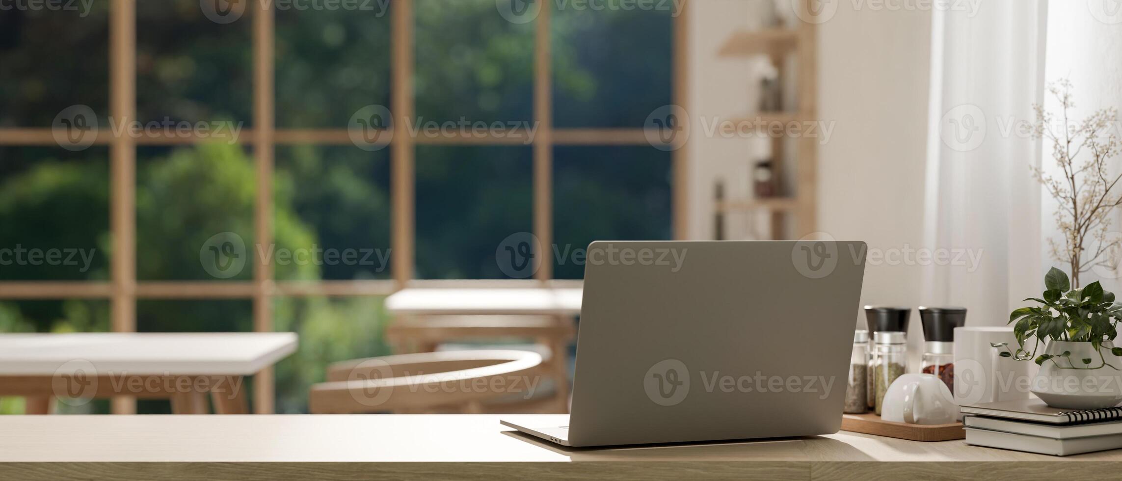 A back view image of a laptop on a wooden table in a cosy Scandinavian coffee shop co-working space photo