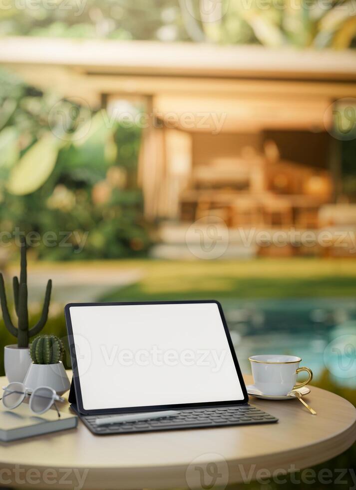 A digital tablet mockup on a table by the pool in a beautiful outdoor garden of a home villa. photo