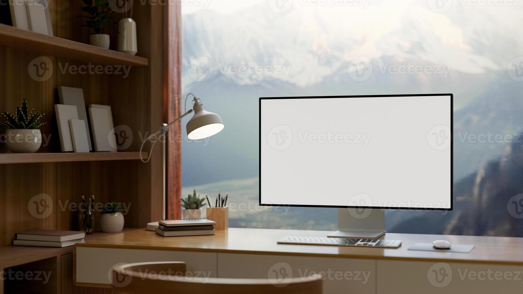 A home office features a computer mockup against the window with a view of snow-capped mountains. photo